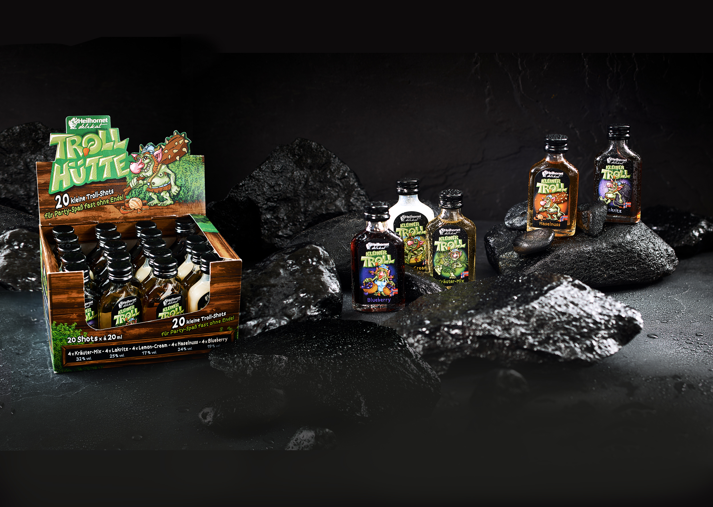 Auswahl an Kleiner-Troll-Shots mit verschiedenen Geschmacksrichtungen in Verpackungen und Einzelflaschen auf einer strukturierten Oberfläche. – Fishing Adventure GmbH